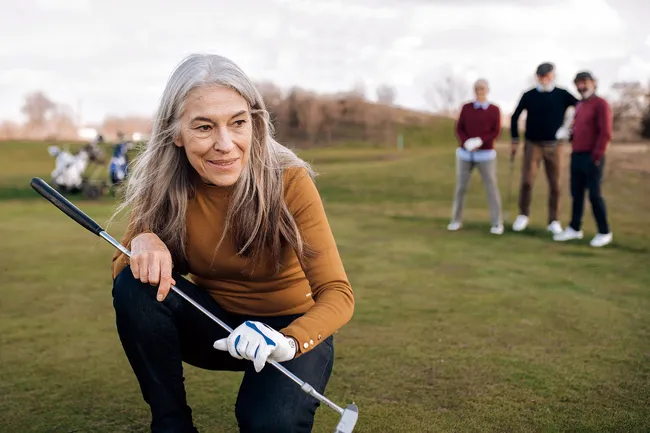 photo of senior woman playing golf