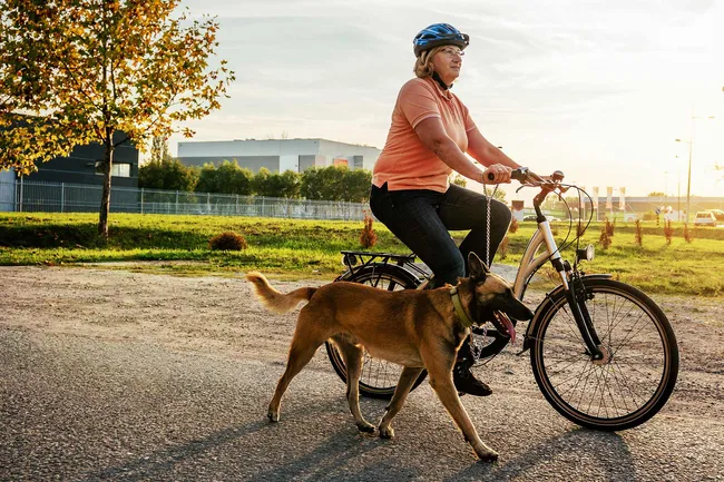 photo of senior woman riding bicycle