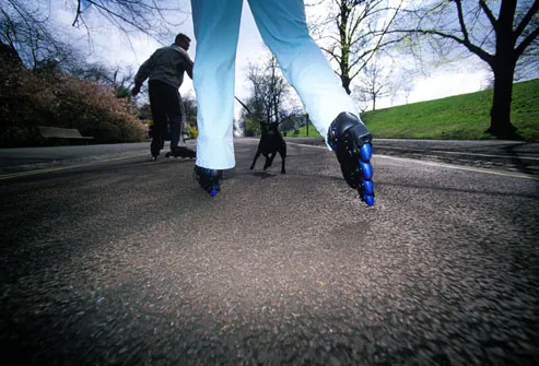 Couple Inline Skating With Dog