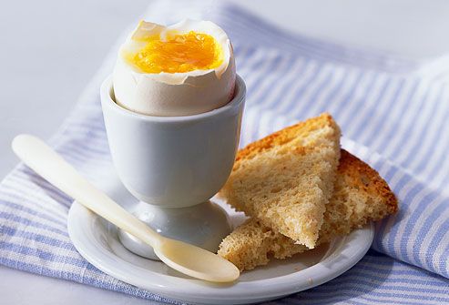 Boiled egg in cup with wheat toast