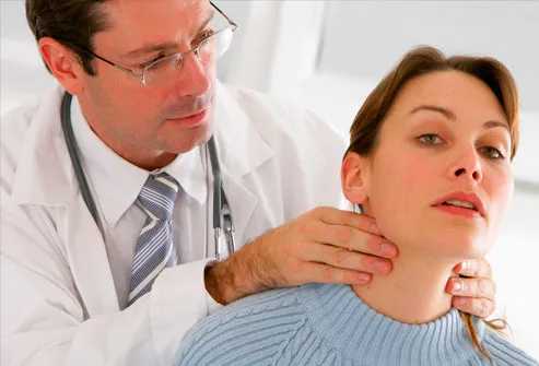 Doctor examining a female patient's thyroid gland