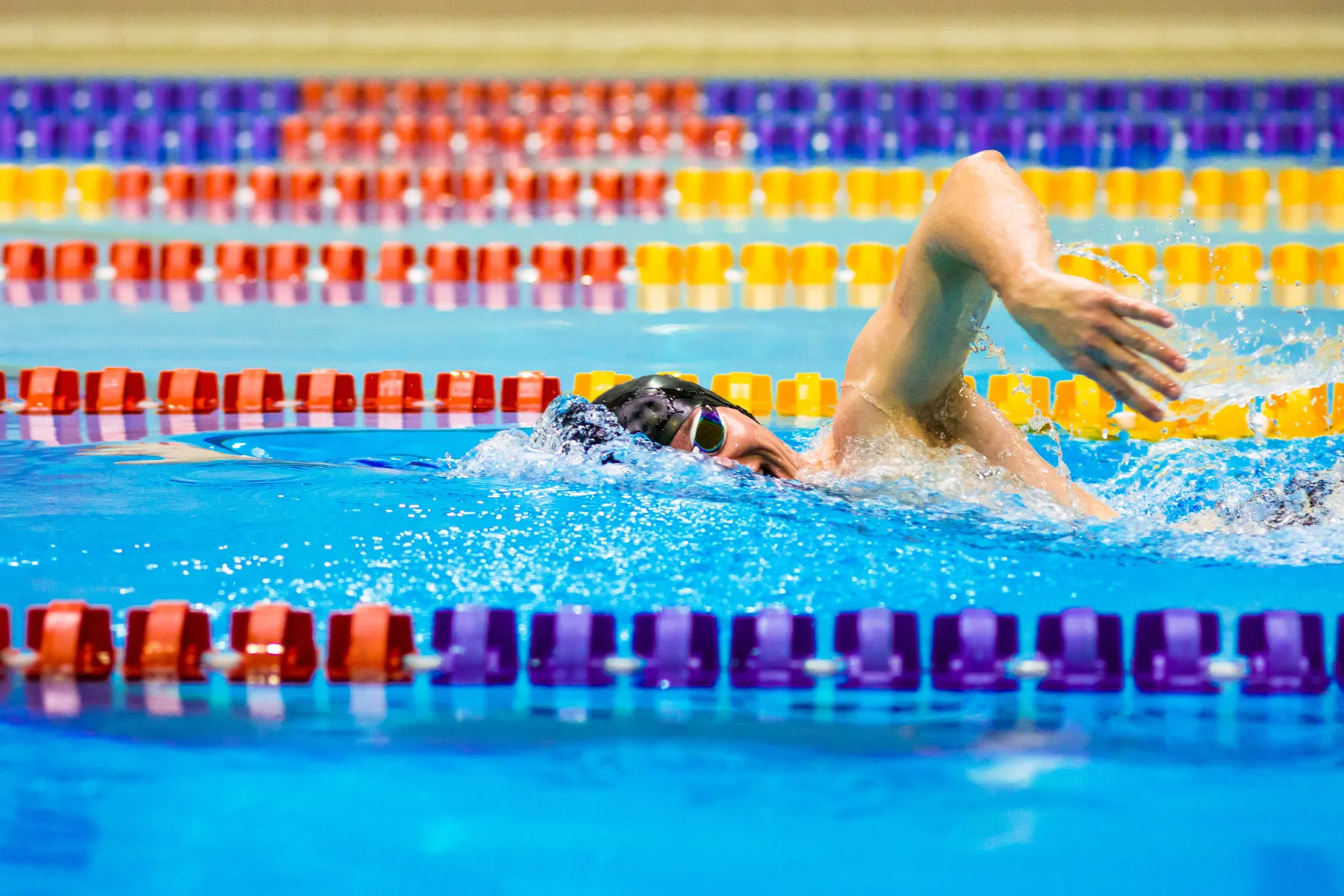 photo of man swimming laps