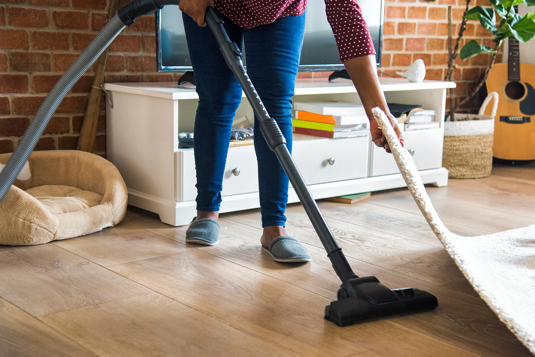 photo of woman vacuuming floor