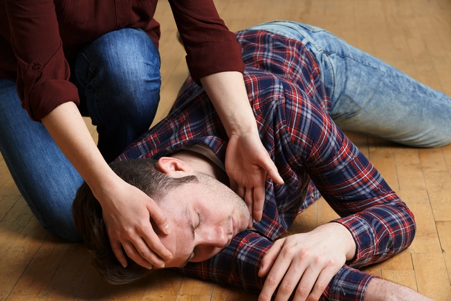 Do: Roll an Unconscious Person on Their Side