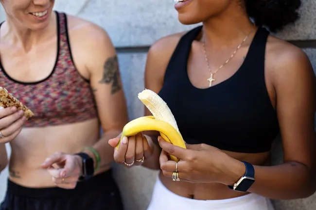photo of woman eating banana