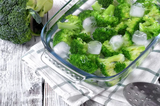 photo of blanched broccoli in cold water