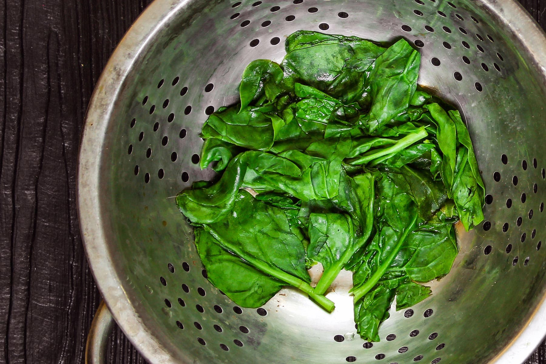 photo of draining spinach in colander