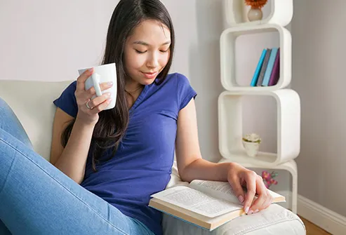 woman relaxing with book