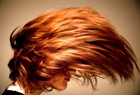 redheaded woman flipping hair