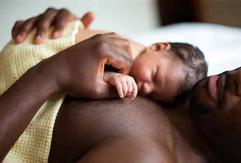 newborn sleeping on fathers chest