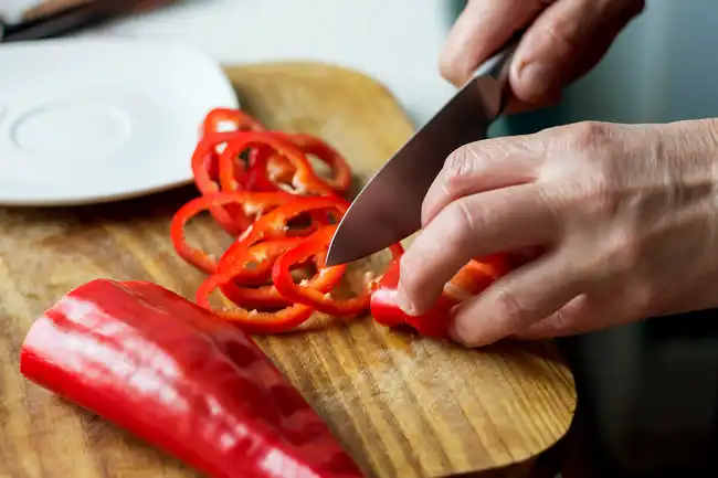 person cutting pepper