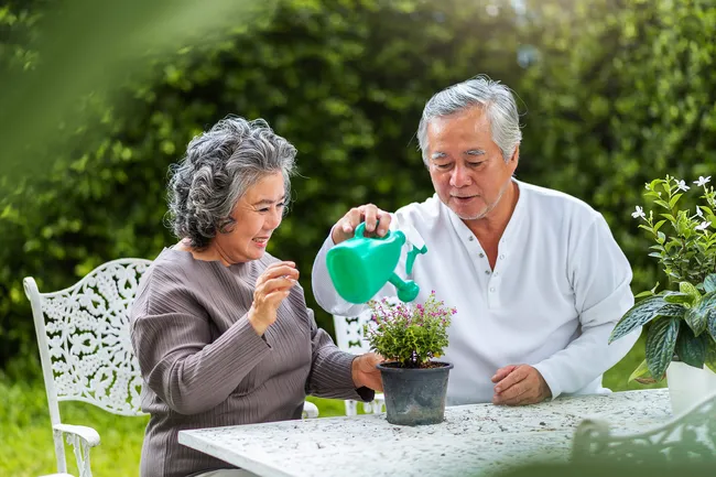 photo of couple watering plant