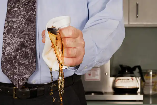 man crushing coffee cup