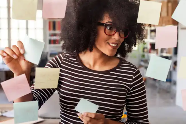 woman putting up post it notes