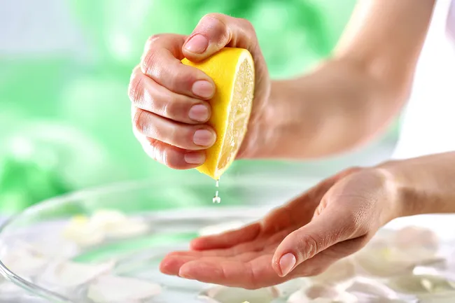 photo of squeezing lemon juice into hand