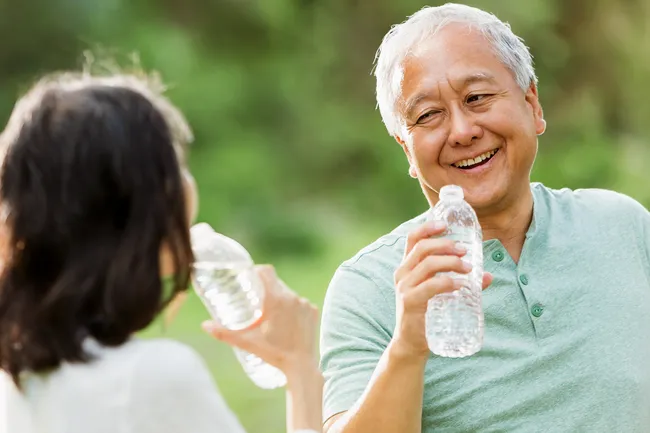 photo of mature couple with water bottles