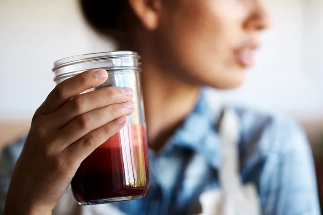 photo of woman drinking juice