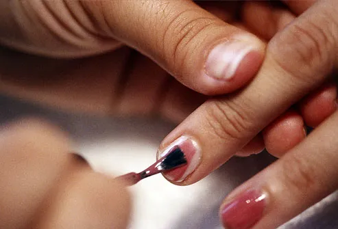 Someone applying nail polish for manicure