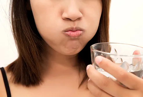 woman sloshing salt water in mouth