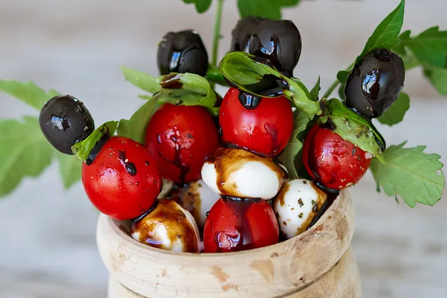 photo of cheese tomato olive spears