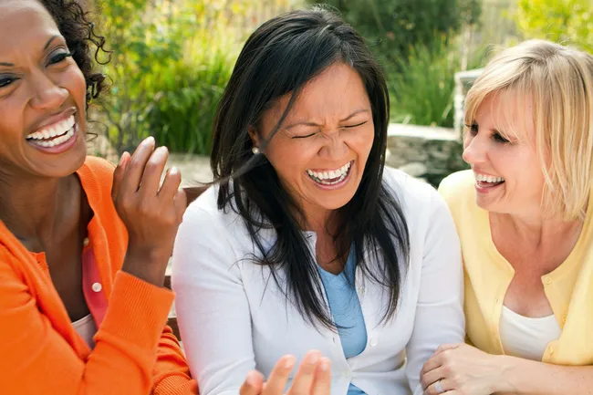 photo of group of female friends laughing