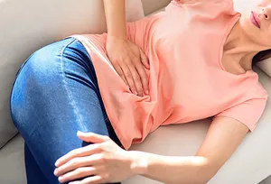 woman on the sofa with menstrual pain