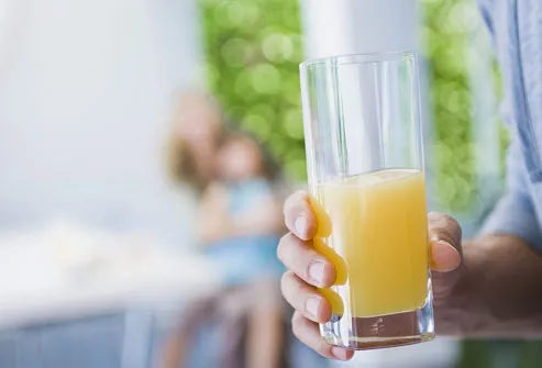 Man Holding Glass of Orange Juice