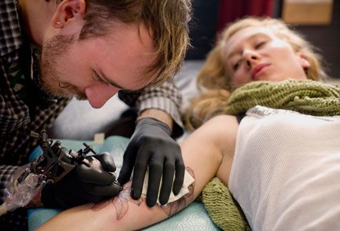 Woman Getting Tattoo on Arm