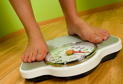 bare feet standing on a weight scale
