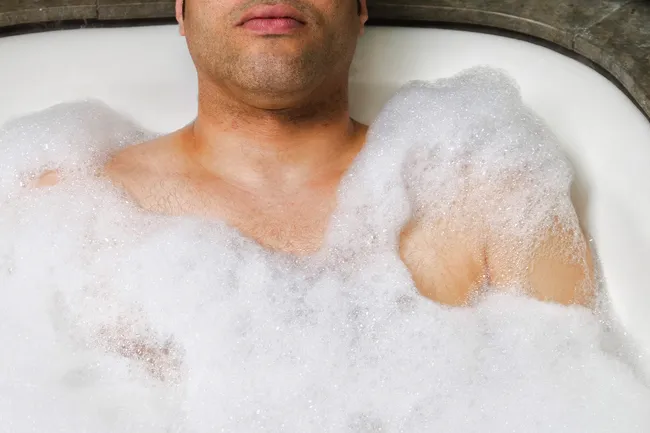 photo of man soaking in the bathtub