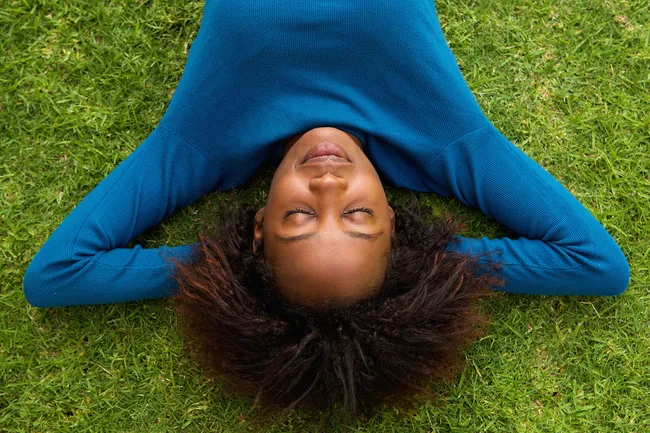 photo of woman relaxing in grass