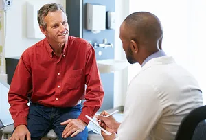 mature man talking with doctor