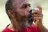 photo of man using asthma inhaler