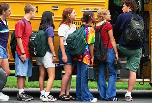 teens getting on school bus