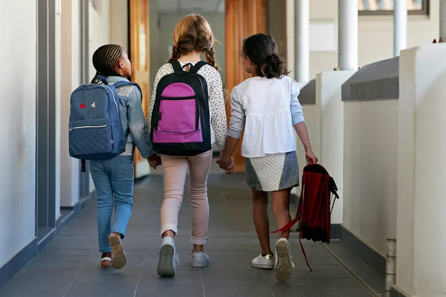 photo of children walking in school