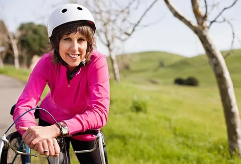 https://img.webmd.com/dtmcms/live/webmd/consumer_assets/site_images/articles/health_tools/live_well_over_50/getty_rf_photo_of_woman_biking.jpg