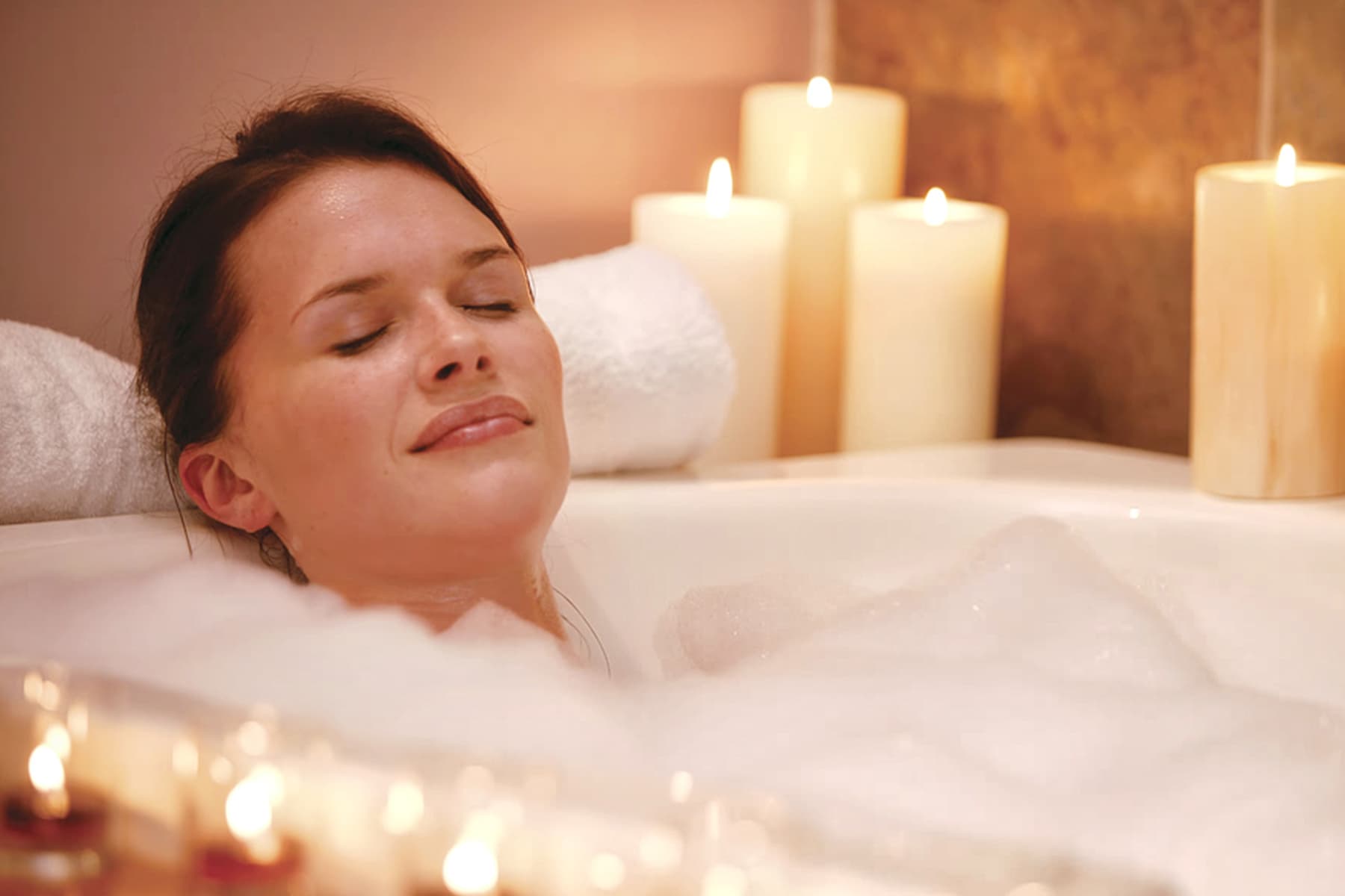 photo of woman taking a relaxing bath