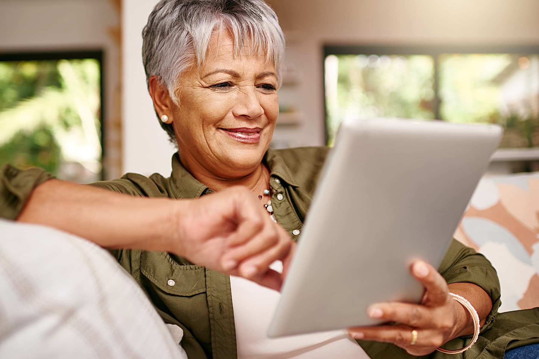 photo of senior woman using computer tablet