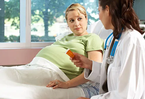 Doctor explaining meds to pregnant woman