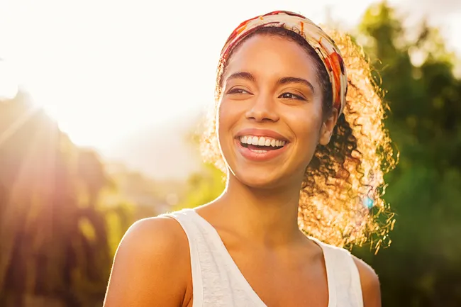 photo of person smiling in sunlight