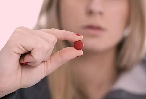 woman holding red pill
