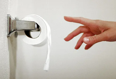 reaching for toilet paper