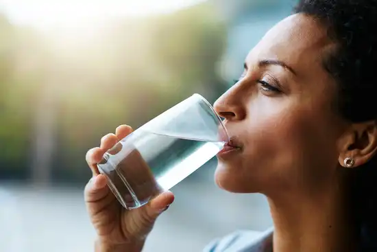 photo of woman drinking water
