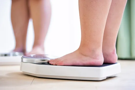 photo of mature woman's feet on weight scale