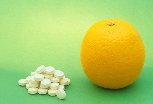 Vitamin C tablets and an Orange