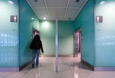 Woman rushing to public restroom