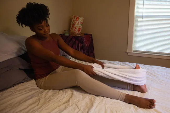 photo of person using towel to stretch