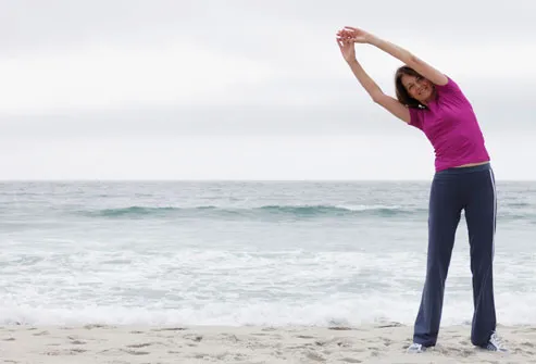 Woman Stretching On Beach