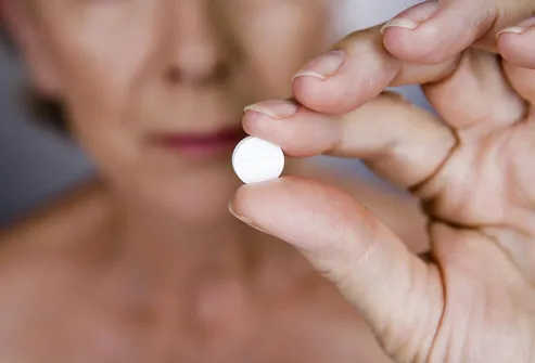 Senior Woman Holding White Pill
