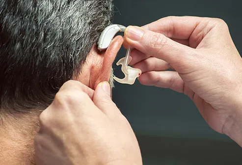 man being fitted with hearing aid